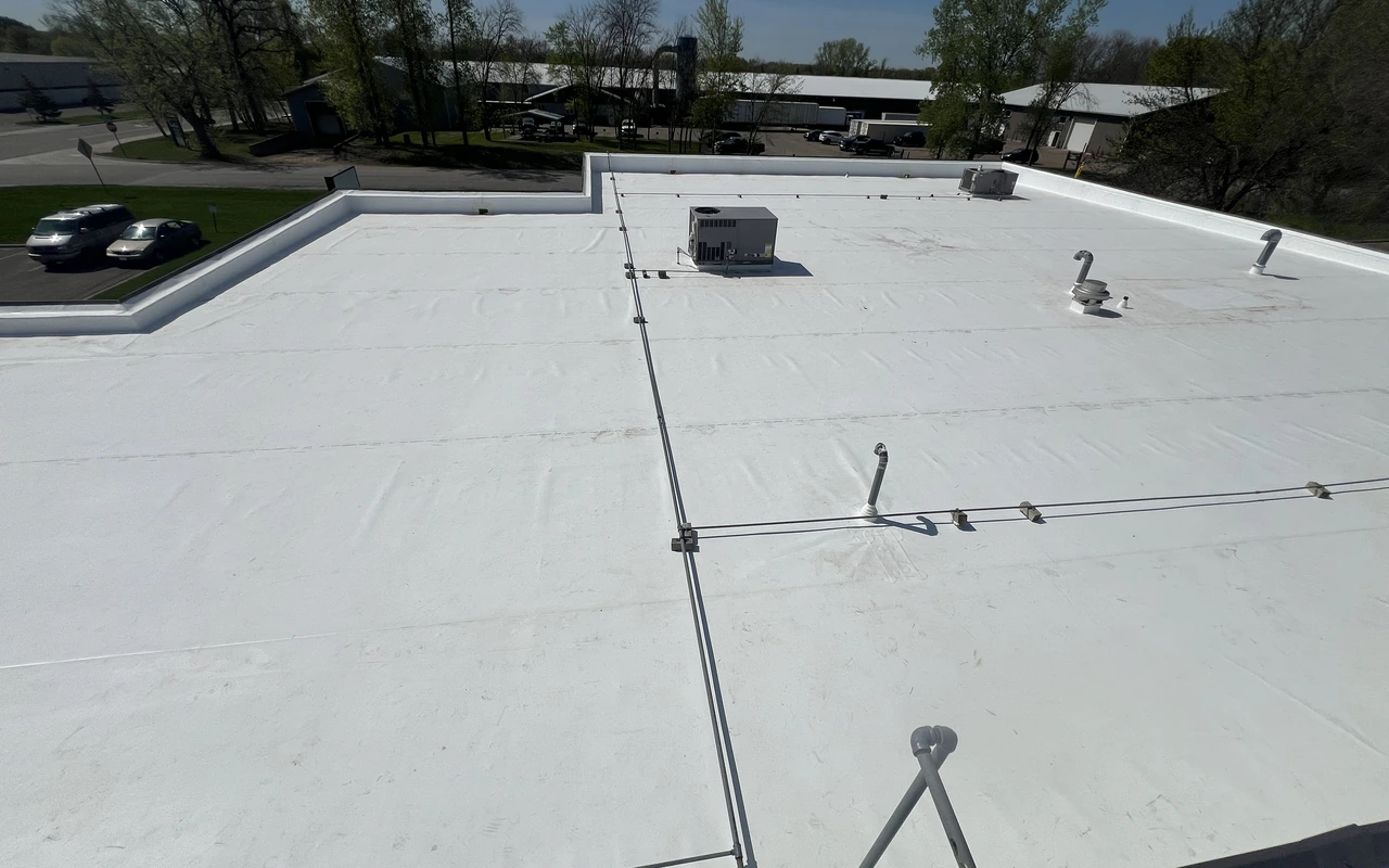 Low-slope modified bitumen roofing on industrial building in Roseville, MN by Altus Roofing