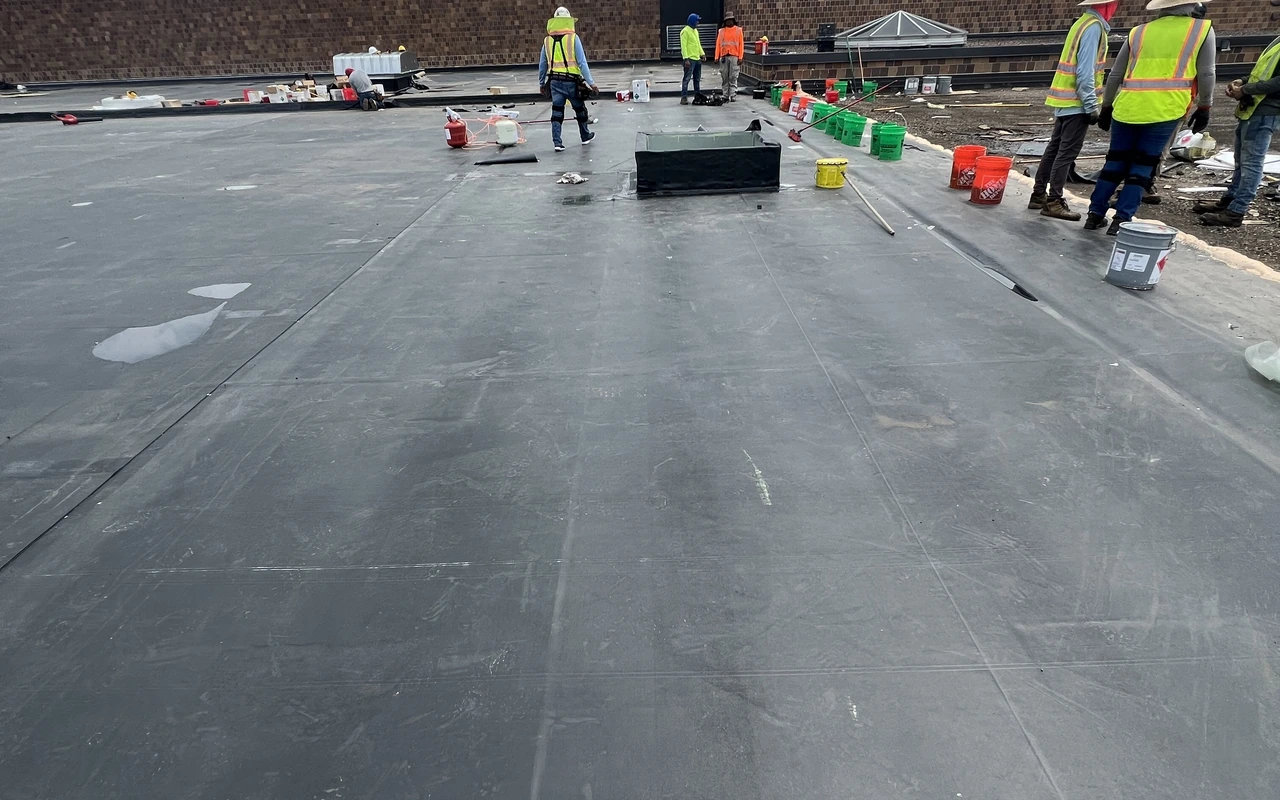 EPDM commercial flat roof installation with crew in Minneapolis, MN by Altus Roofing