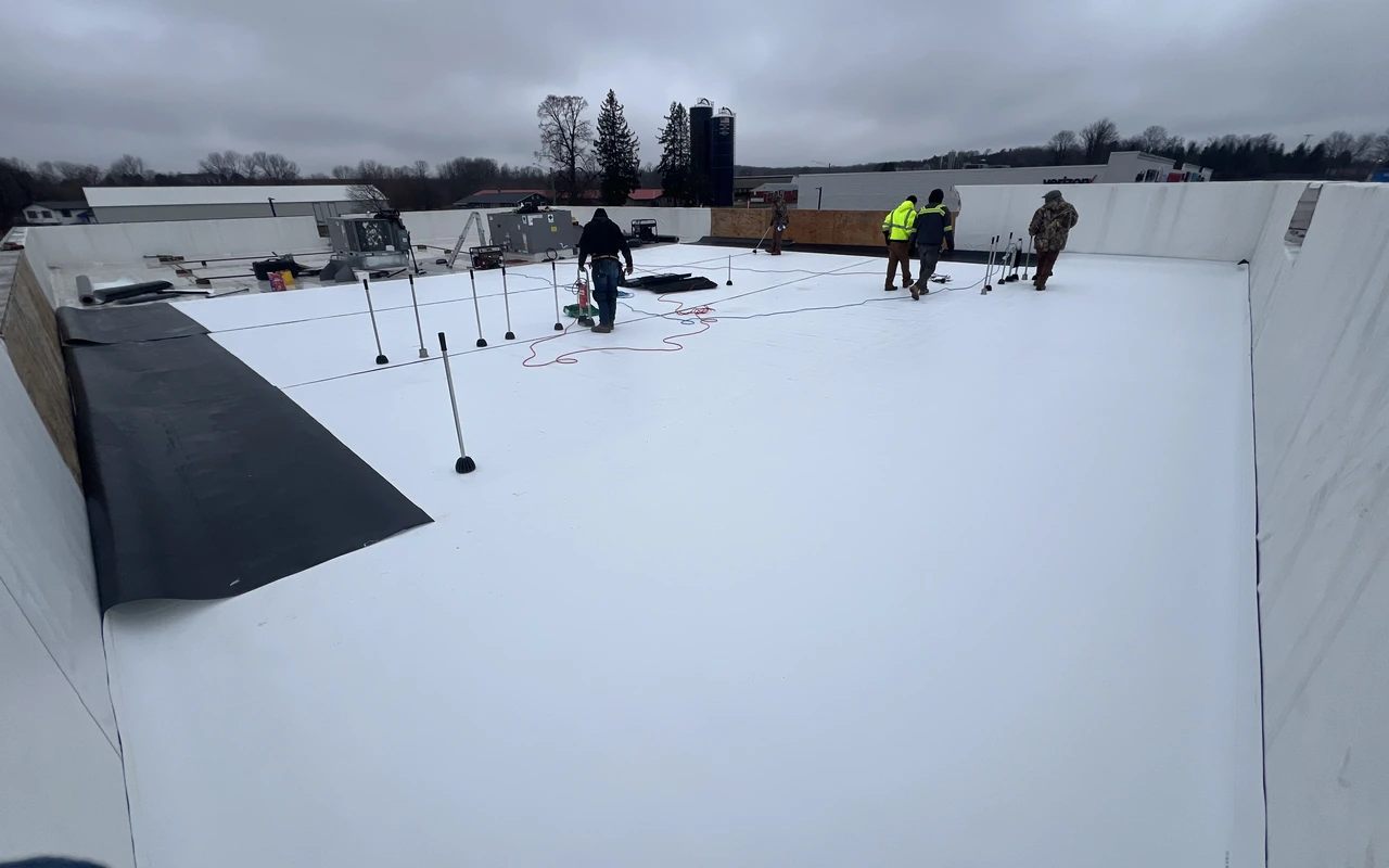Commercial TPO flat roof installation in winter weather in Minneapolis, MN by Altus Roofing